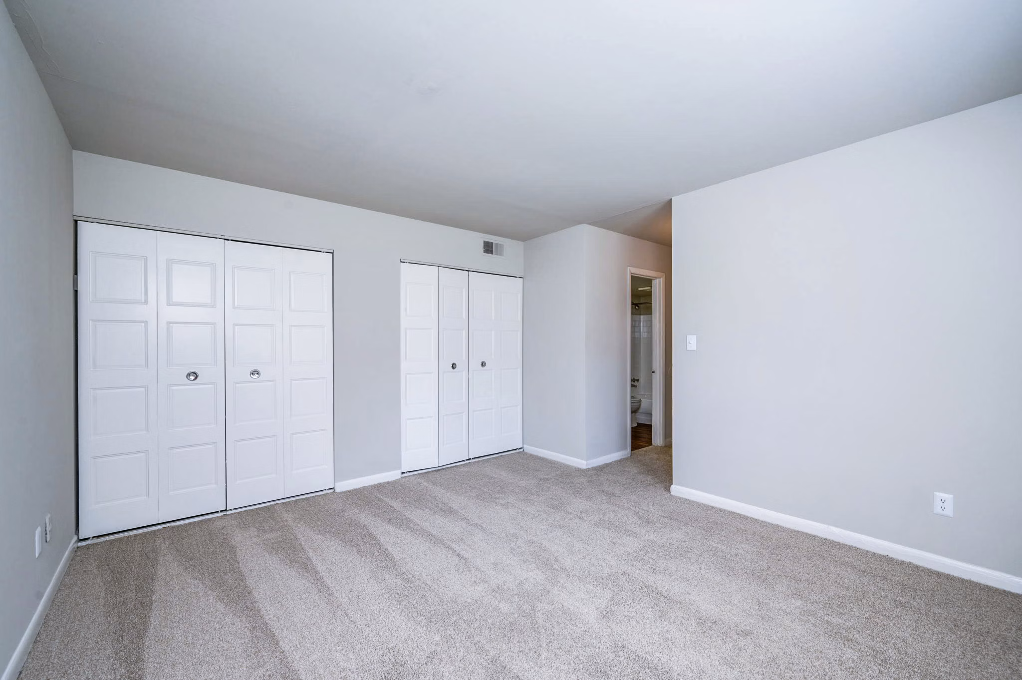 Cozy bedroom with modern design elements at Woodshire Apartments