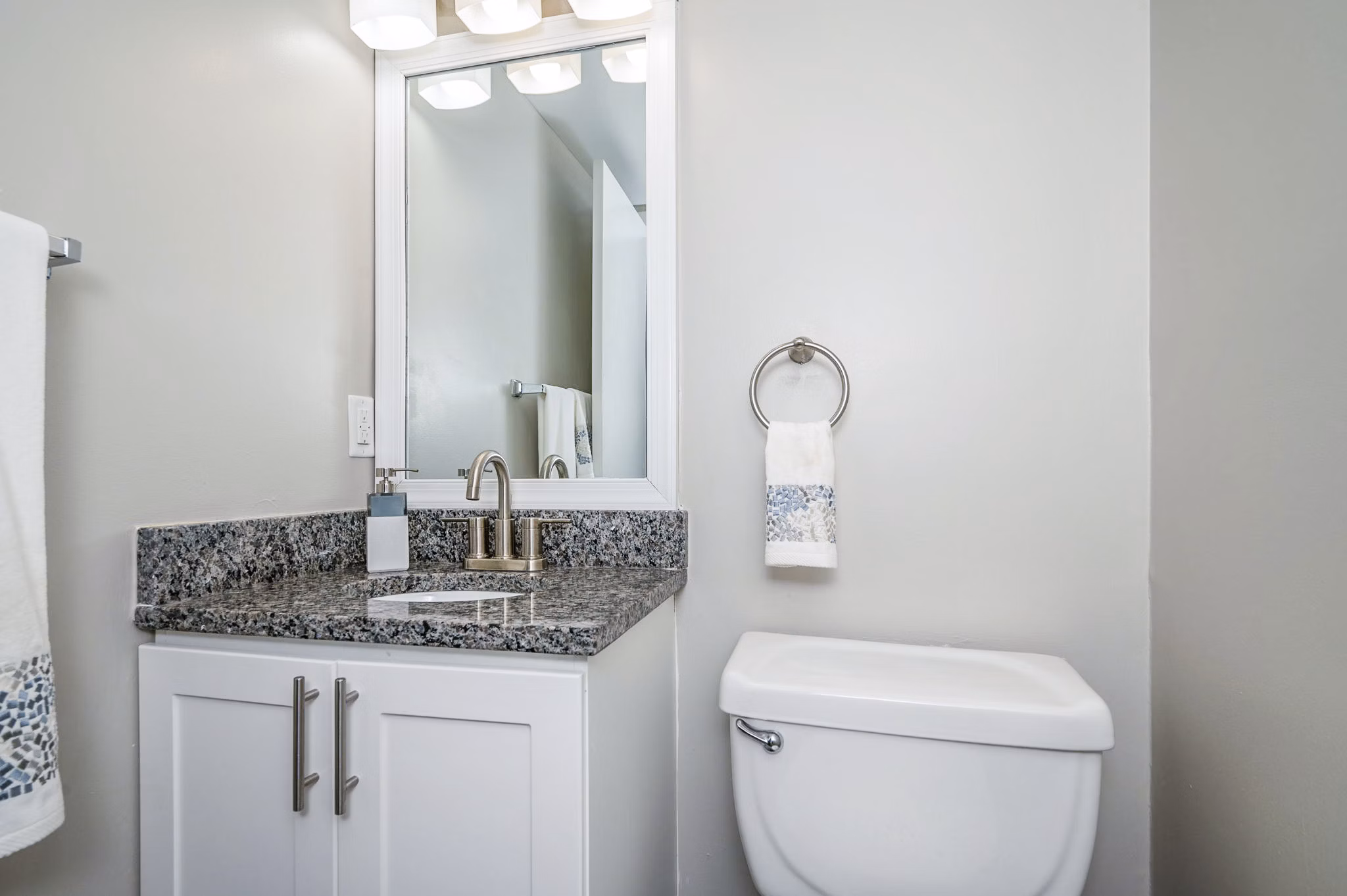 Modern bathroom with sleek fixtures at Woodshire Apartments, featuring elegant tilework and spacious vanity in this luxury apartment