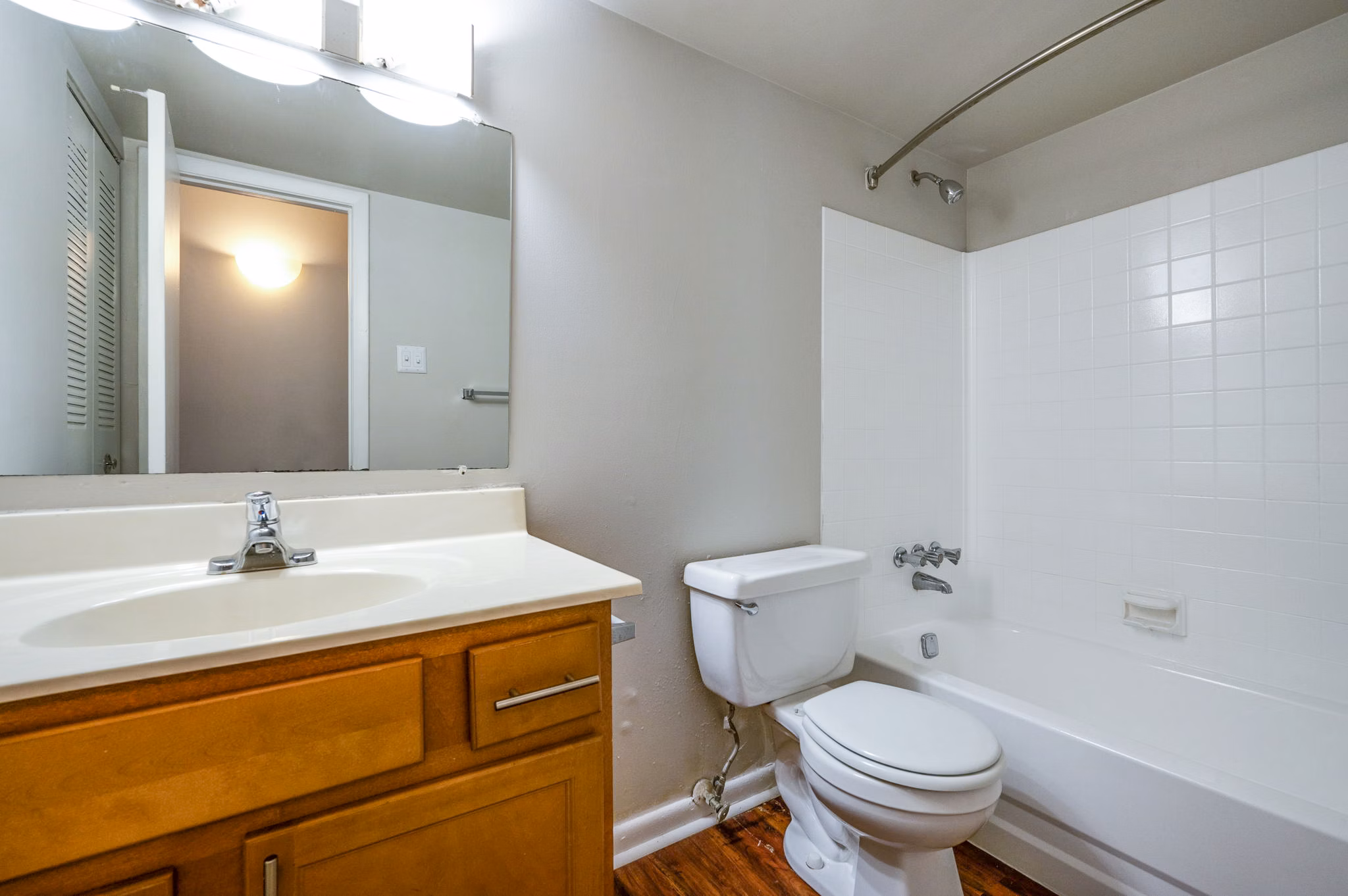 Modern bathroom featuring sleek fixtures and marble countertops in Woodshire Apartments