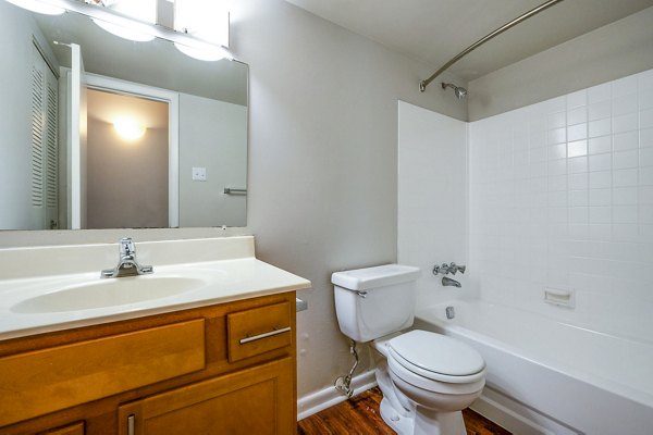 Modern bathroom featuring sleek fixtures and marble countertops in Woodshire Apartments