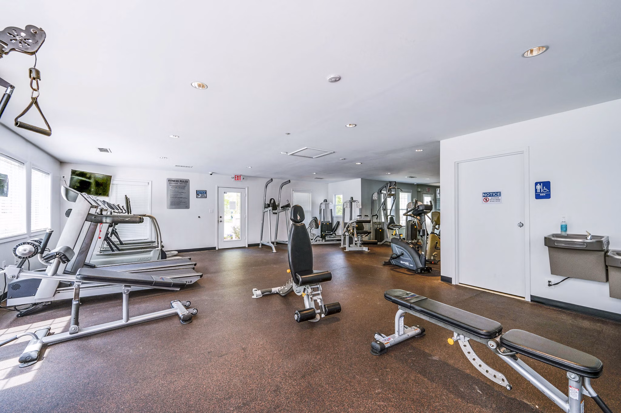 Modern fitness center with state-of-the-art equipment at Woodshire Apartments