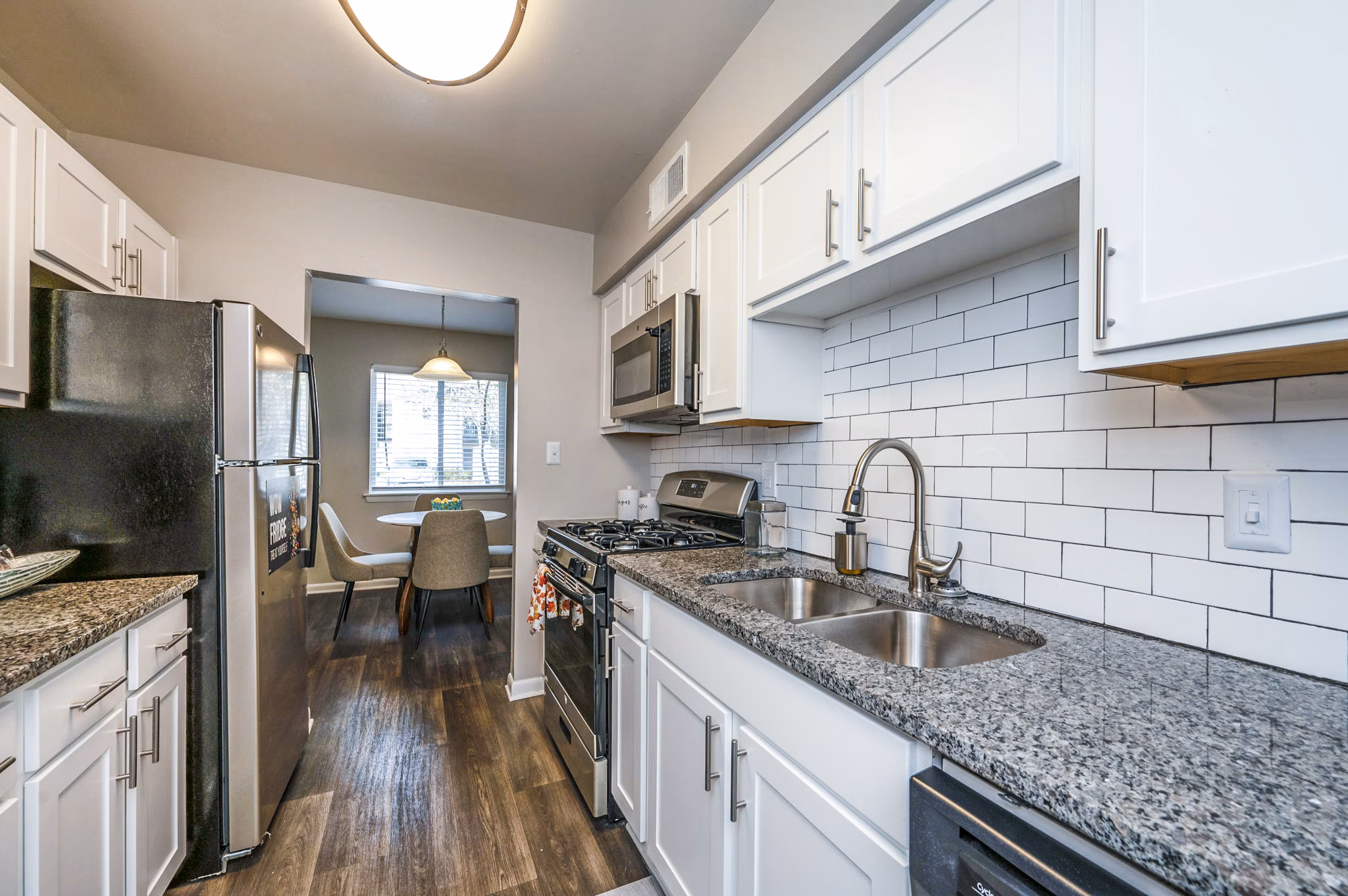 Modern kitchen featuring stainless steel appliances in Woodshire Apartments