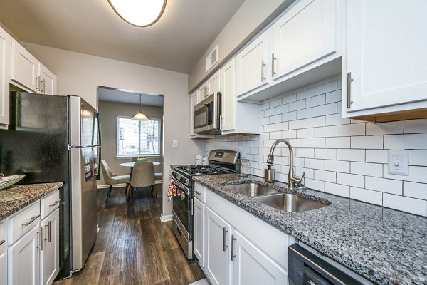 Modern kitchen featuring stainless steel appliances in Woodshire Apartments
