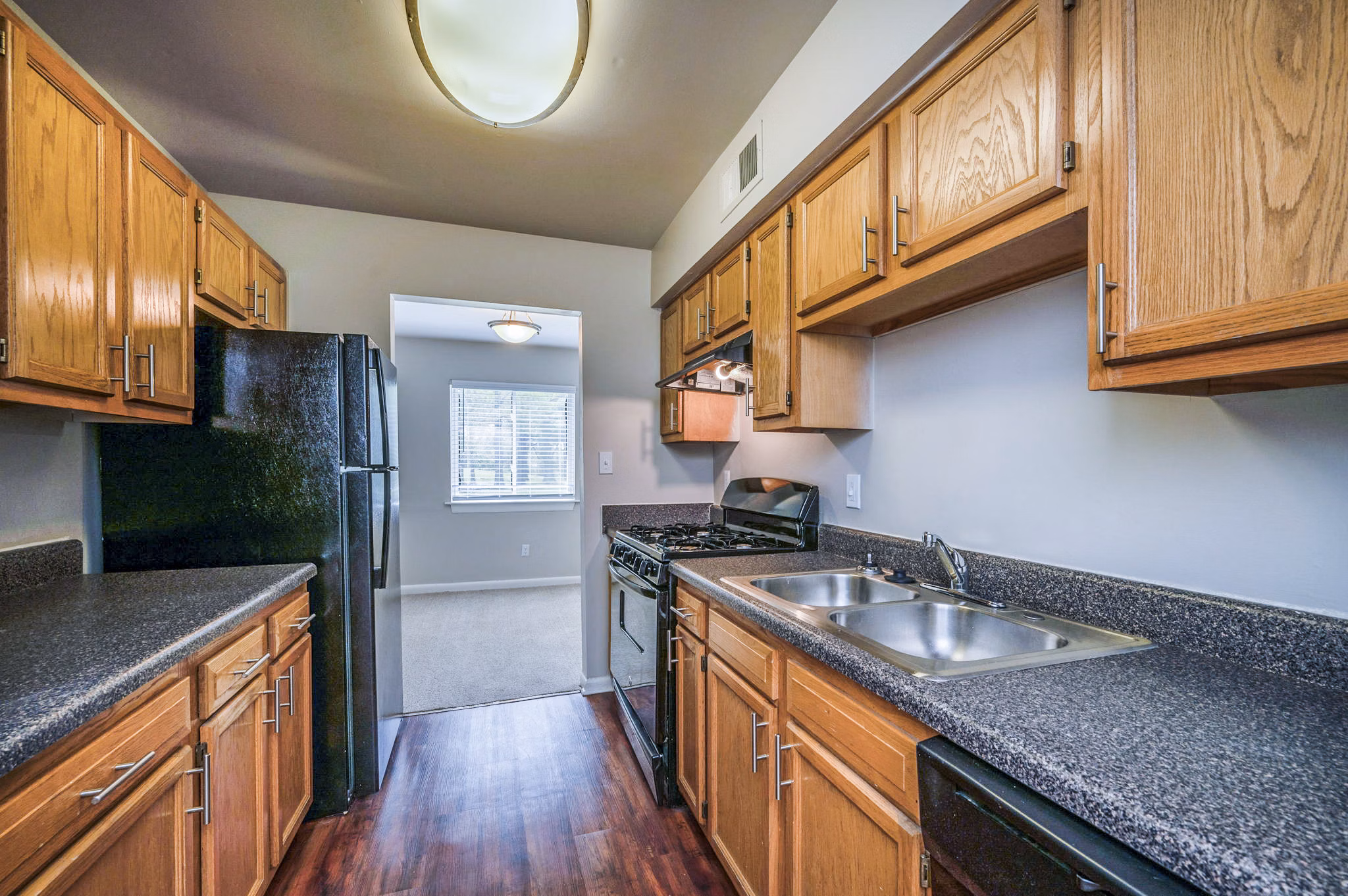 Modern kitchen with stainless steel appliances at Woodshire Apartments luxury rental