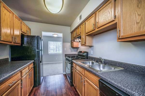 Modern kitchen with stainless steel appliances at Woodshire Apartments luxury rental