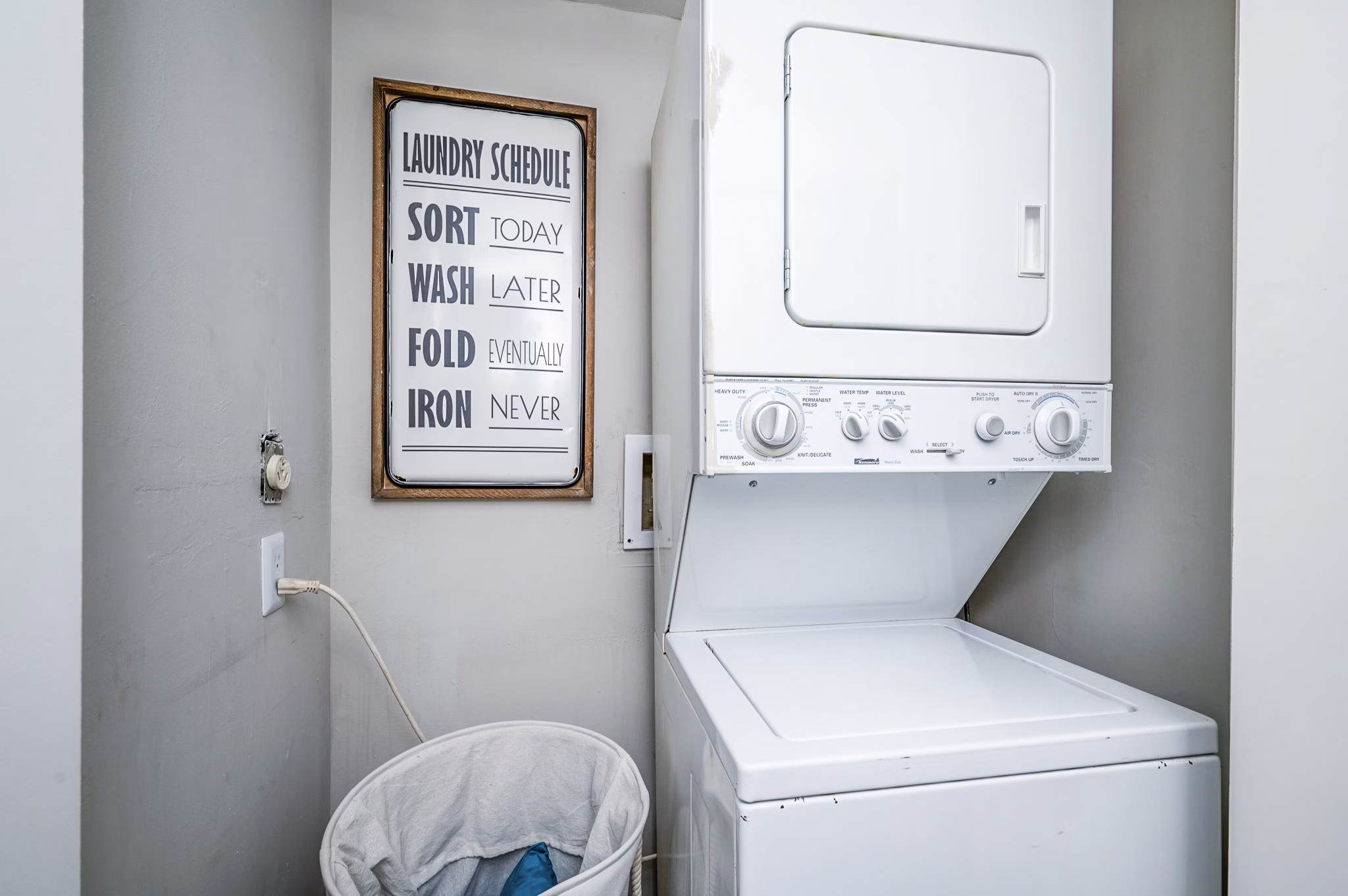 Laundry room featuring modern appliances at Woodshire Apartments