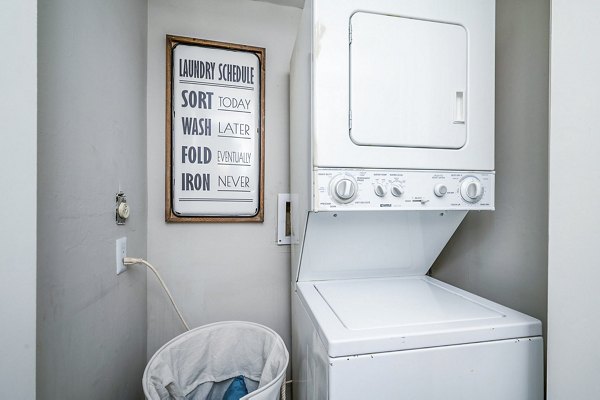 Laundry room featuring modern appliances at Woodshire Apartments