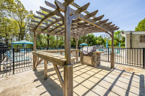 Outdoor grill area with cozy seating at Woodshire Apartmentsâ€”perfect for entertaining or relaxing