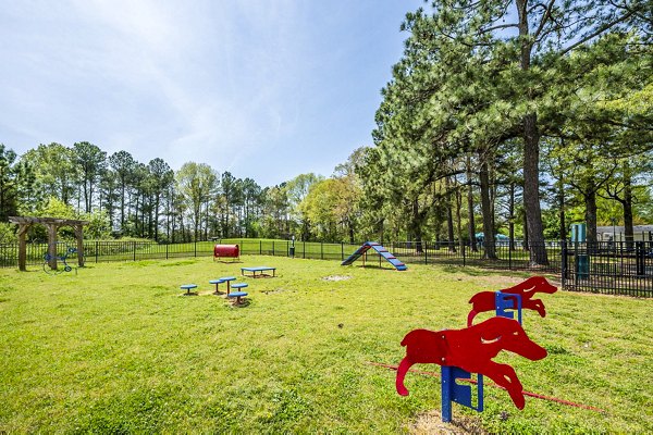 Leash-free dog park with agility equipment at Woodshire Apartments