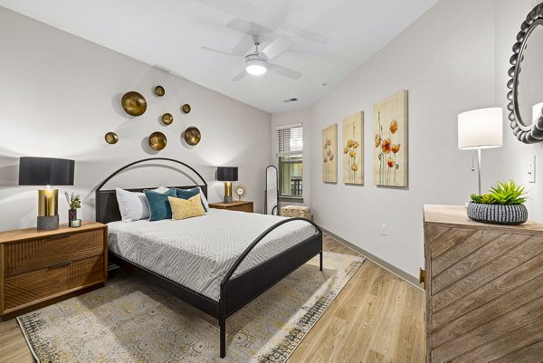 Contemporary bedroom featuring modern decor and stylish furnishings at The Artreaux Apartments