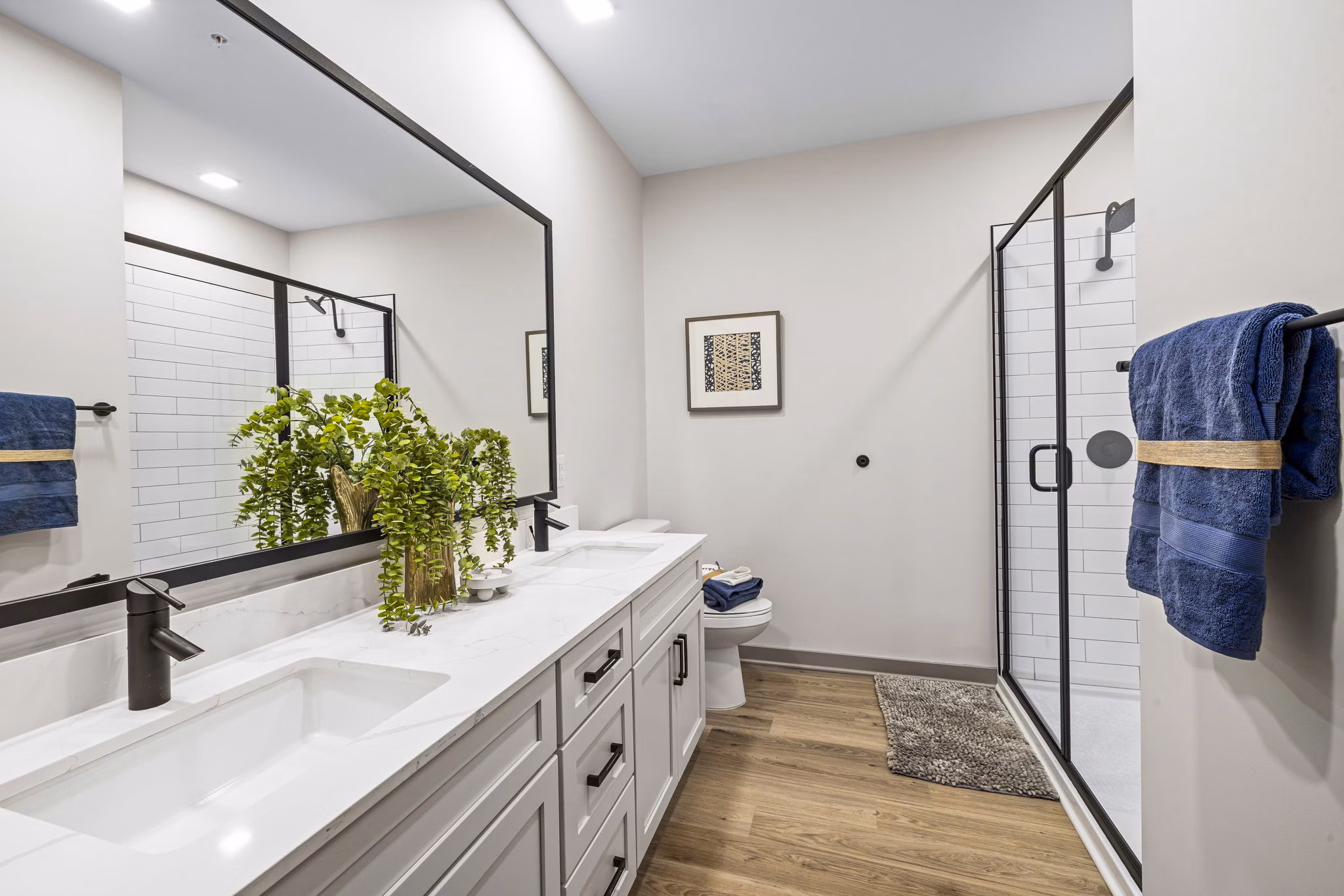 Bathroom featuring modern fixtures and marble countertops in The Artreaux Apartments