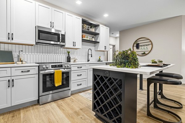Modern kitchen with stainless steel appliances in The Artreaux Apartments