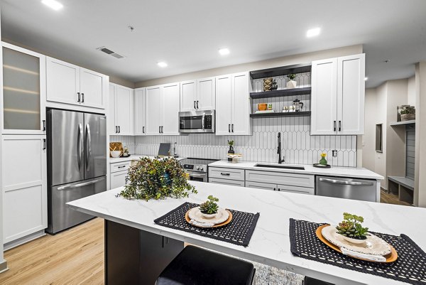 Contemporary kitchen with stainless steel appliances at The Artreaux Apartments in Winston-Salem, NC.