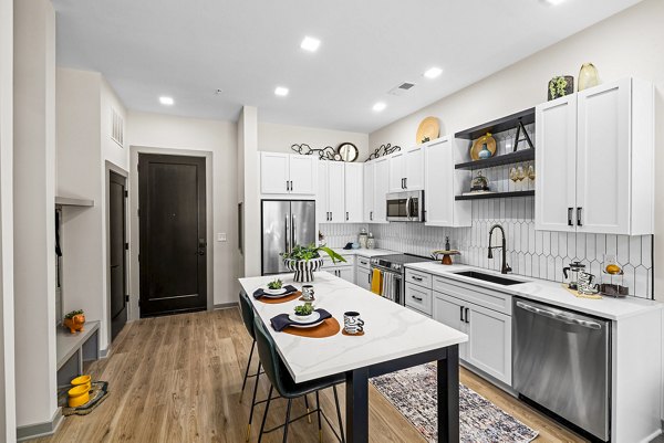 Modern kitchen with stainless steel appliances at The Artreaux Apartments