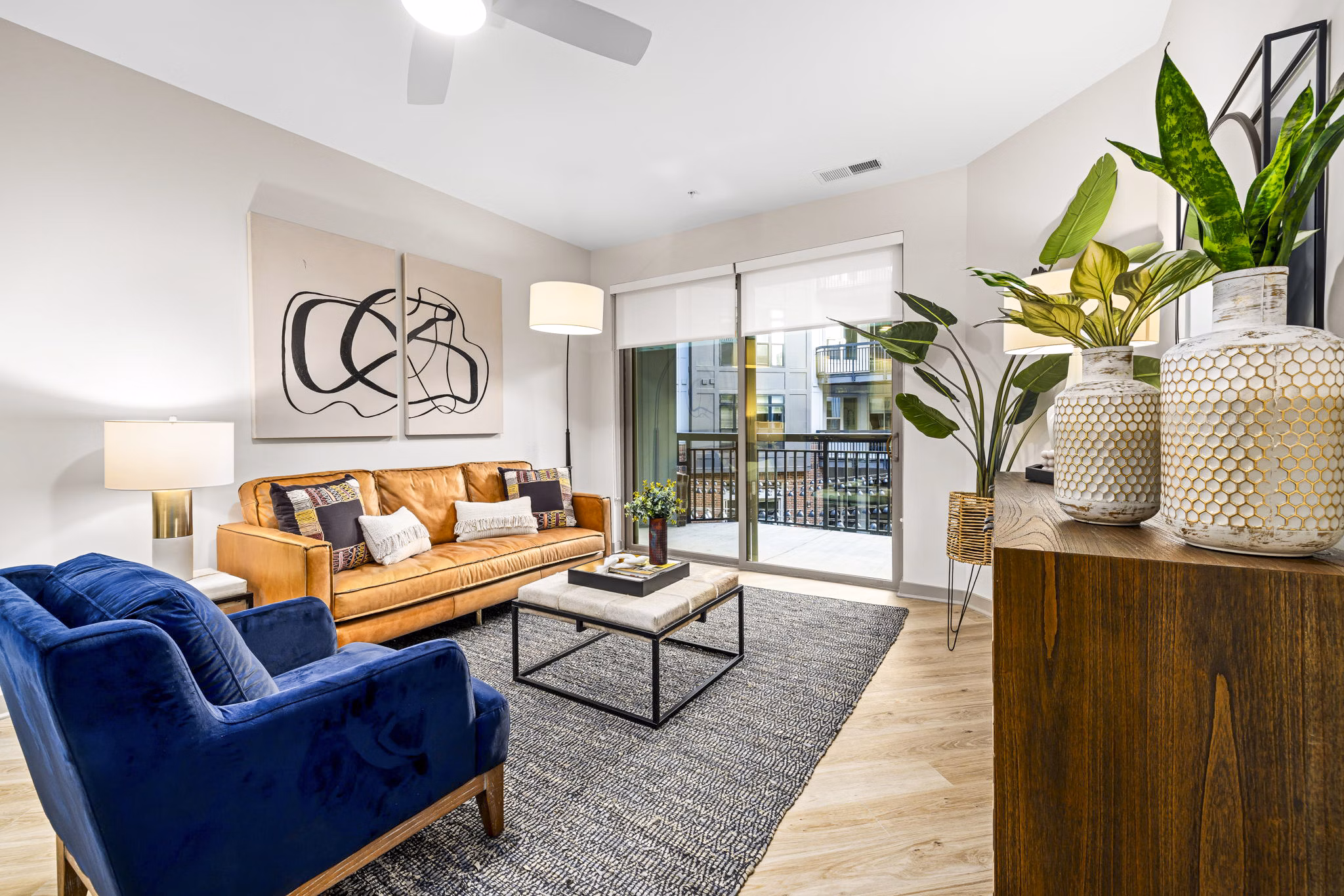 Spacious living room with modern decor in The Artreaux Apartments