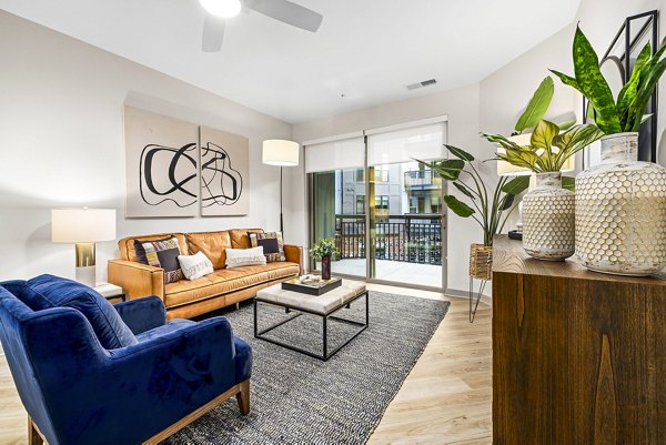 Spacious living room with modern decor in The Artreaux Apartments