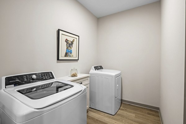 Modern laundry room with energy-efficient machines at The Artreaux Apartments