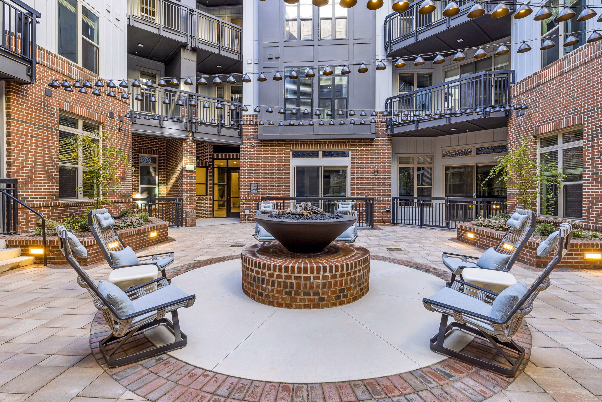 Fire pit and cozy seating on the patio at The Artreaux Apartments for a relaxing outdoor experience
