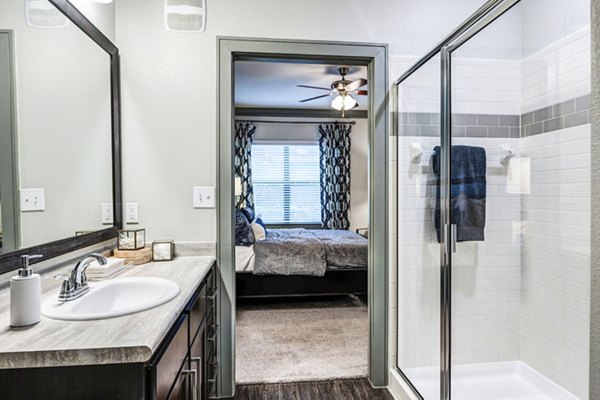 Bathroom featuring modern fixtures and sleek design in Harlow Spring Cypress Apartments
