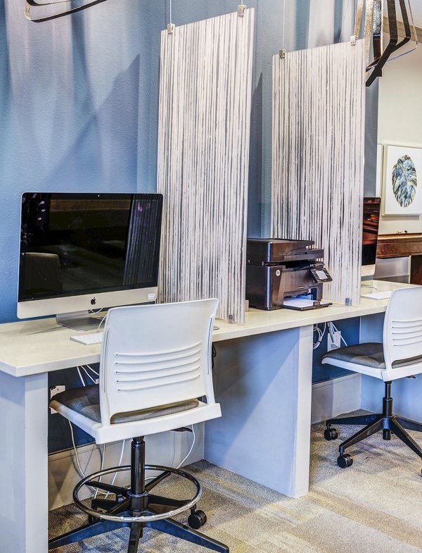 Clubhouse business center at Harlow Spring Cypress Apartments featuring state-of-the-art workstations and meeting spaces for luxury community events