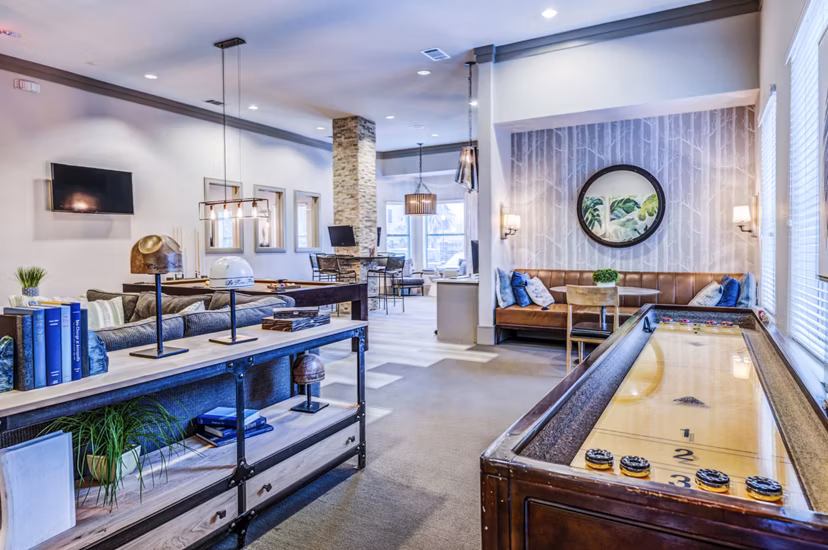 Clubhouse game room with billiards and lounge area at Harlow Spring Cypress Apartments