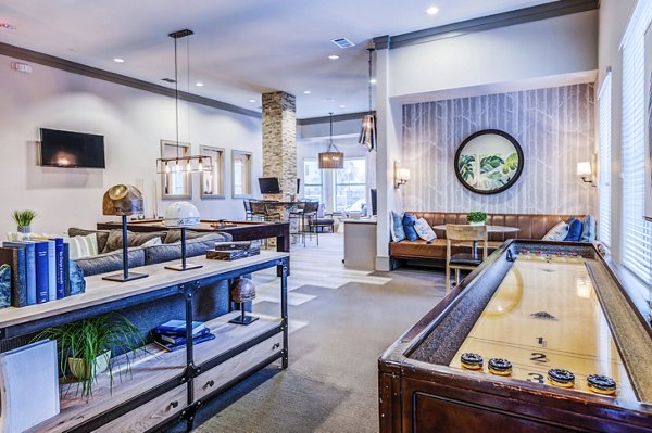 Clubhouse game room with billiards and lounge area at Harlow Spring Cypress Apartments