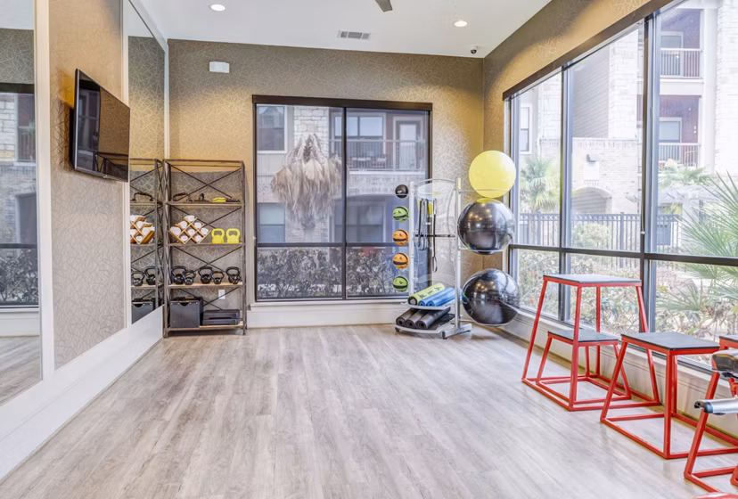 Spacious yoga studio with natural lighting at Harlow Spring Cypress Apartments, perfect for wellness and relaxation in luxury living