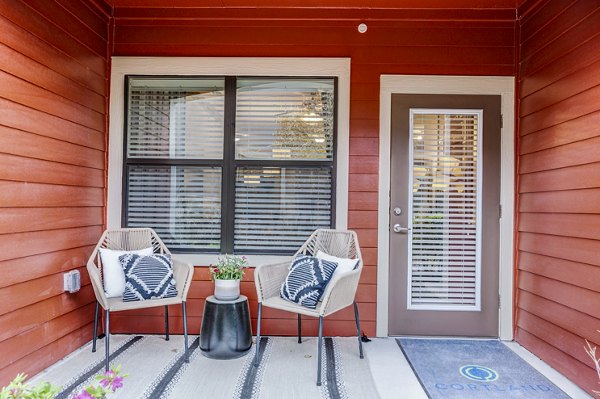 Spacious outdoor patio with modern furniture at Harlow Spring Cypress Apartments