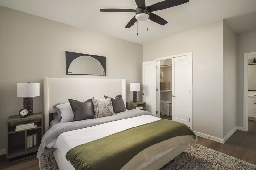 Cozy bedroom with modern furnishings at Smith + Rio Apartments, offering luxury living in a vibrant community