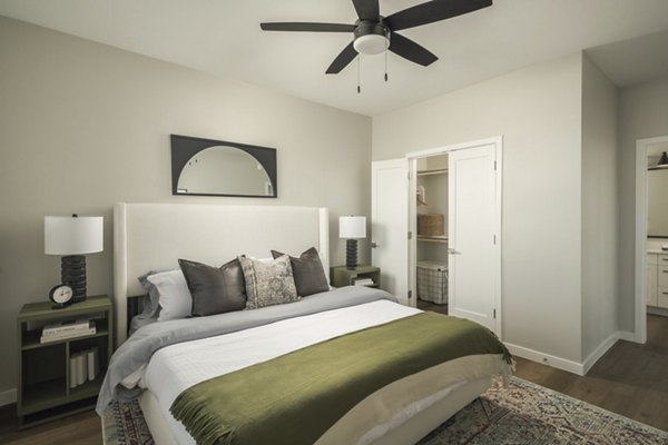 Cozy bedroom with modern furnishings at Smith + Rio Apartments, offering luxury living in a vibrant community