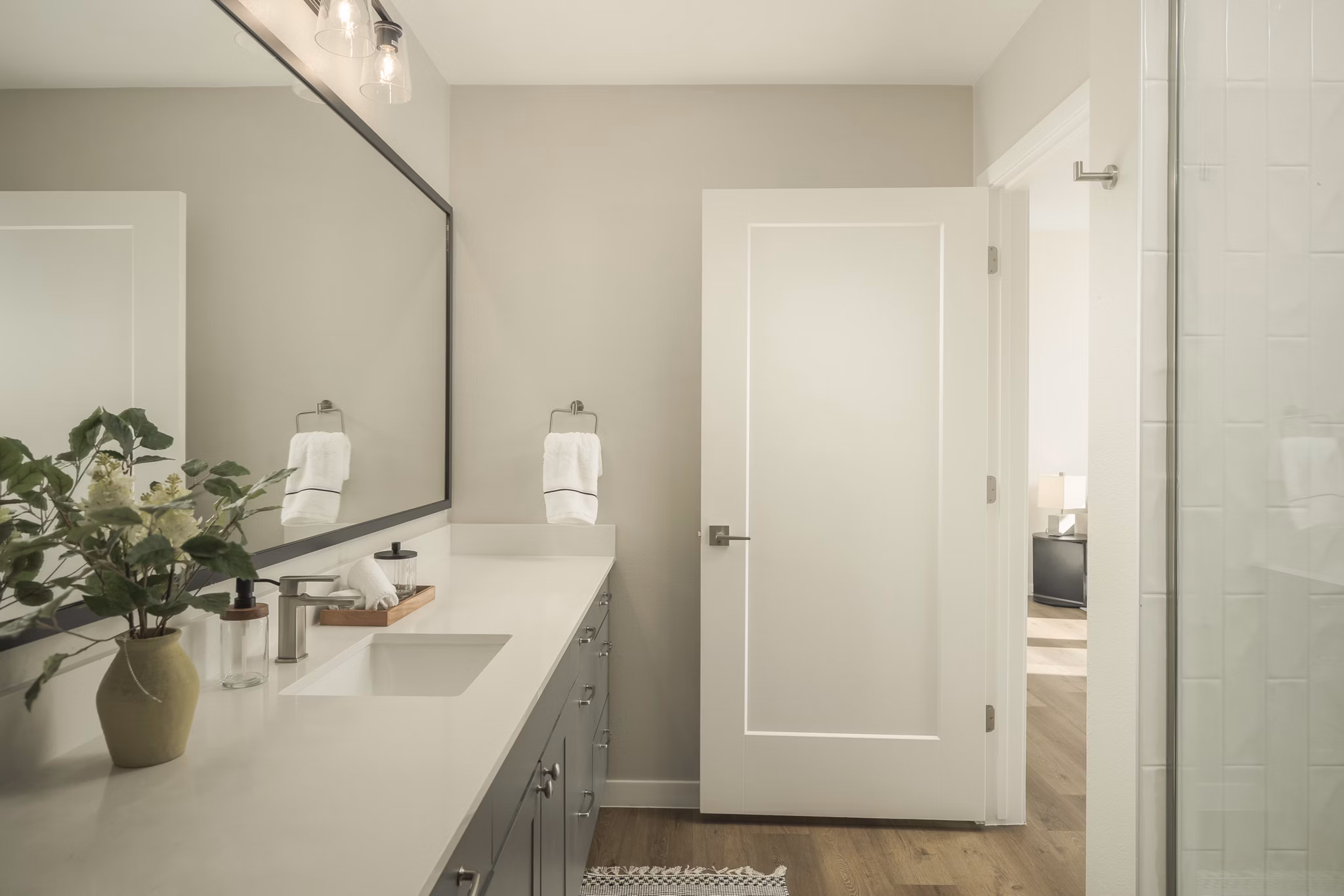 Modern bathroom with dual sinks and marble finishes at Smith + Rio Apartments