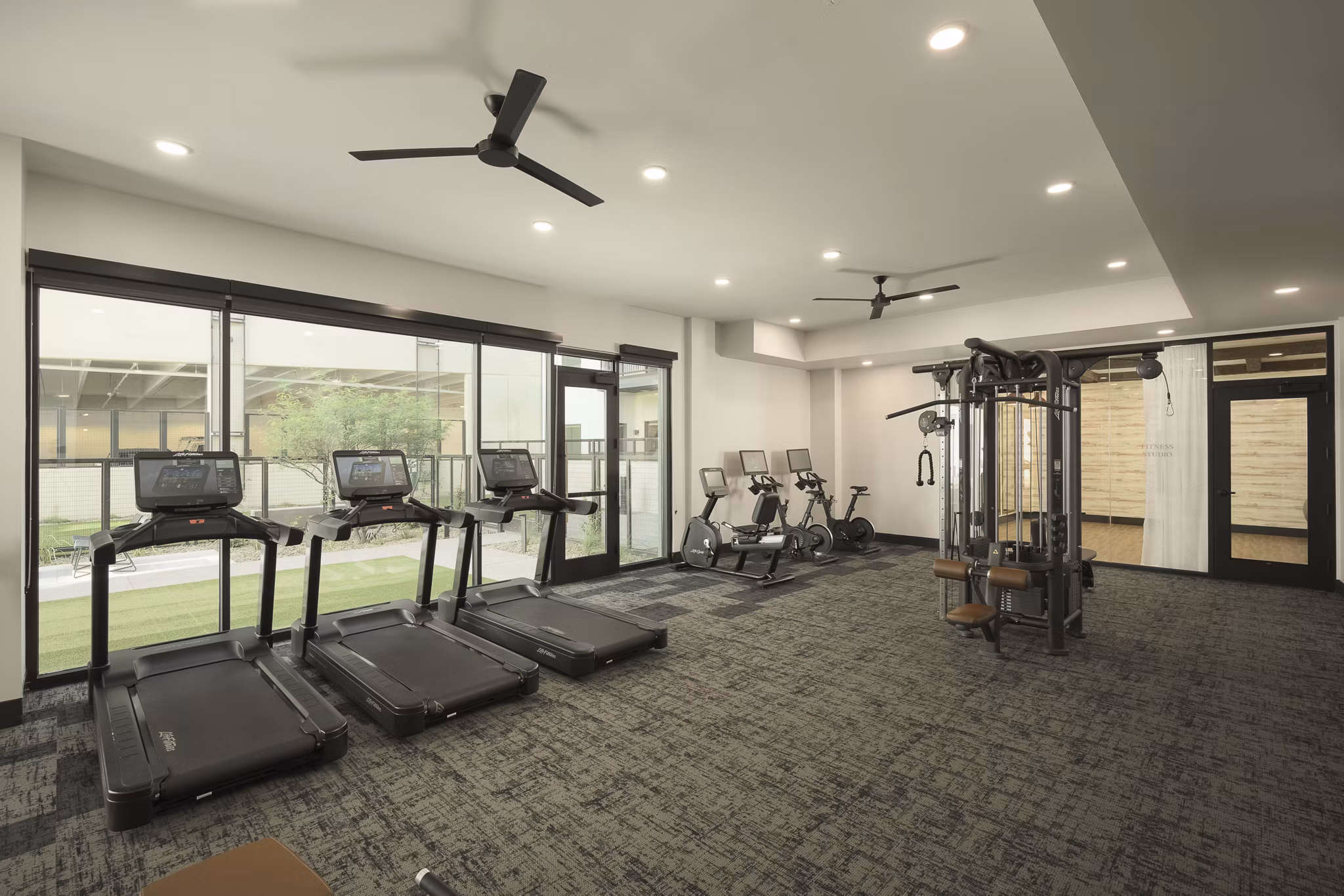 Fitness center featuring state-of-the-art cardio and weight equipment at Smith + Rio Apartments