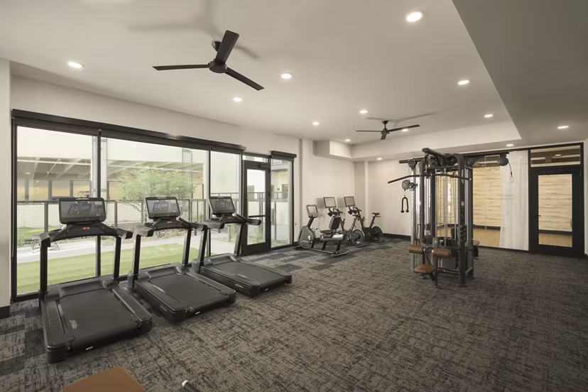 Fitness center featuring state-of-the-art cardio and weight equipment at Smith + Rio Apartments