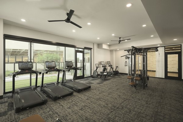 Fitness center featuring state-of-the-art cardio and weight equipment at Smith + Rio Apartments