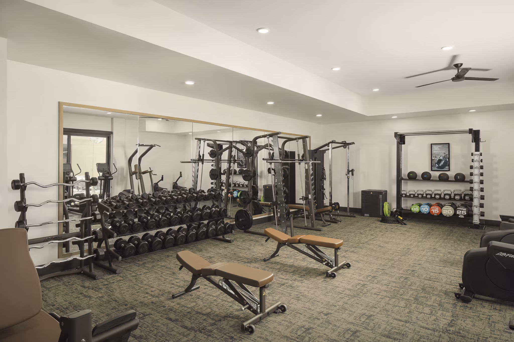 Fully-equipped fitness center at Smith + Rio Apartments featuring modern exercise machines