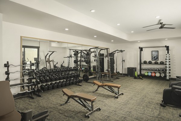 Fully-equipped fitness center at Smith + Rio Apartments featuring modern exercise machines