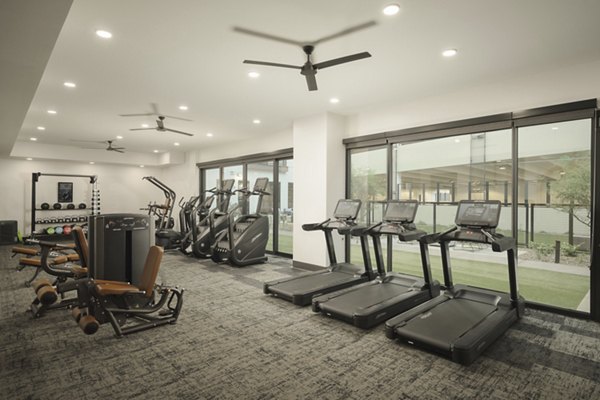 State-of-the-art fitness center with cardio and strength equipment at Smith + Rio Apartments