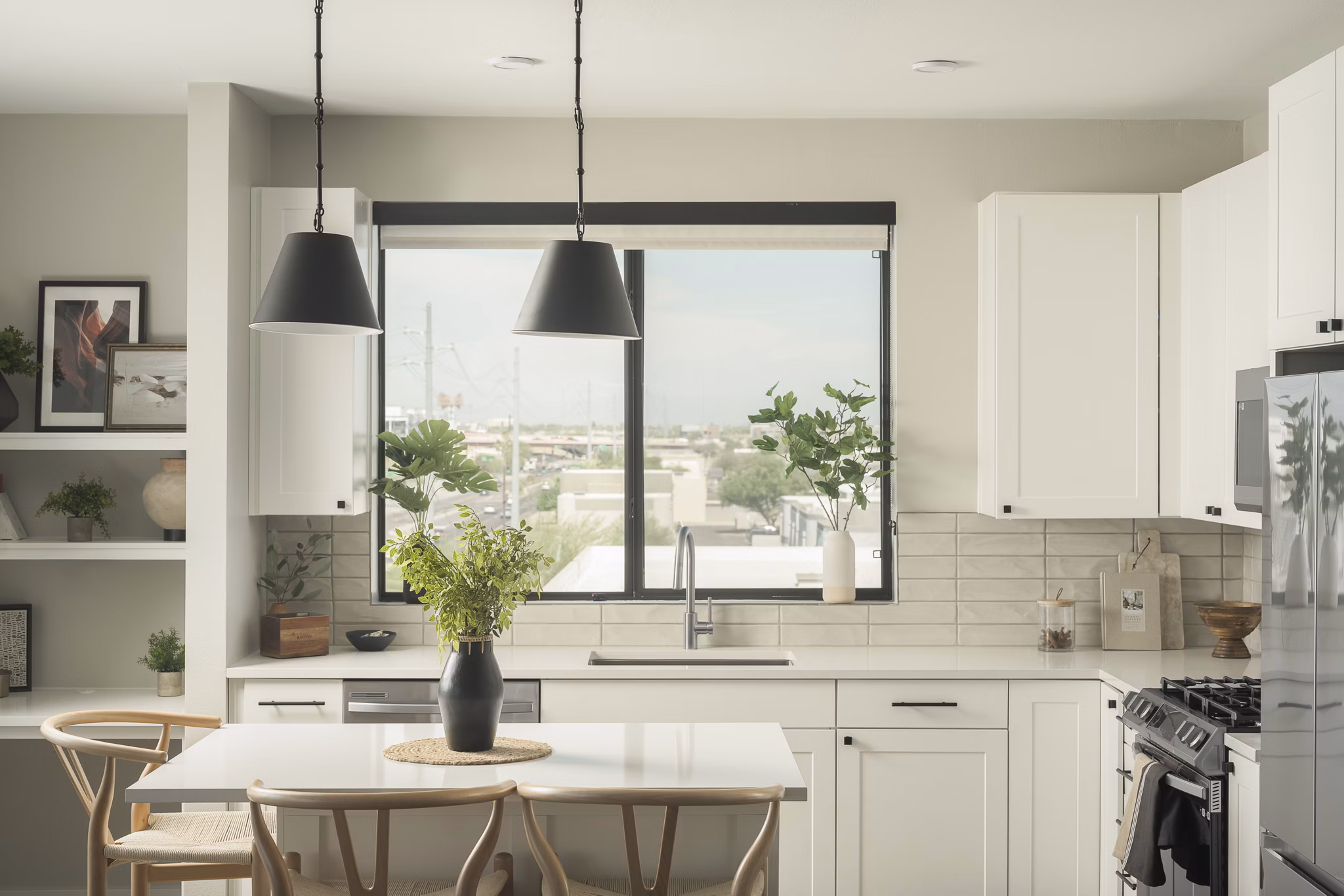 Modern kitchen with stainless steel appliances at Smith + Rio Apartments