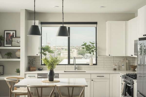 Modern kitchen with stainless steel appliances at Smith + Rio Apartments