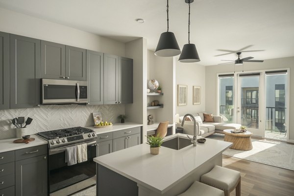 Modern kitchen with stainless steel appliances at Smith + Rio Apartments in vibrant urban setting