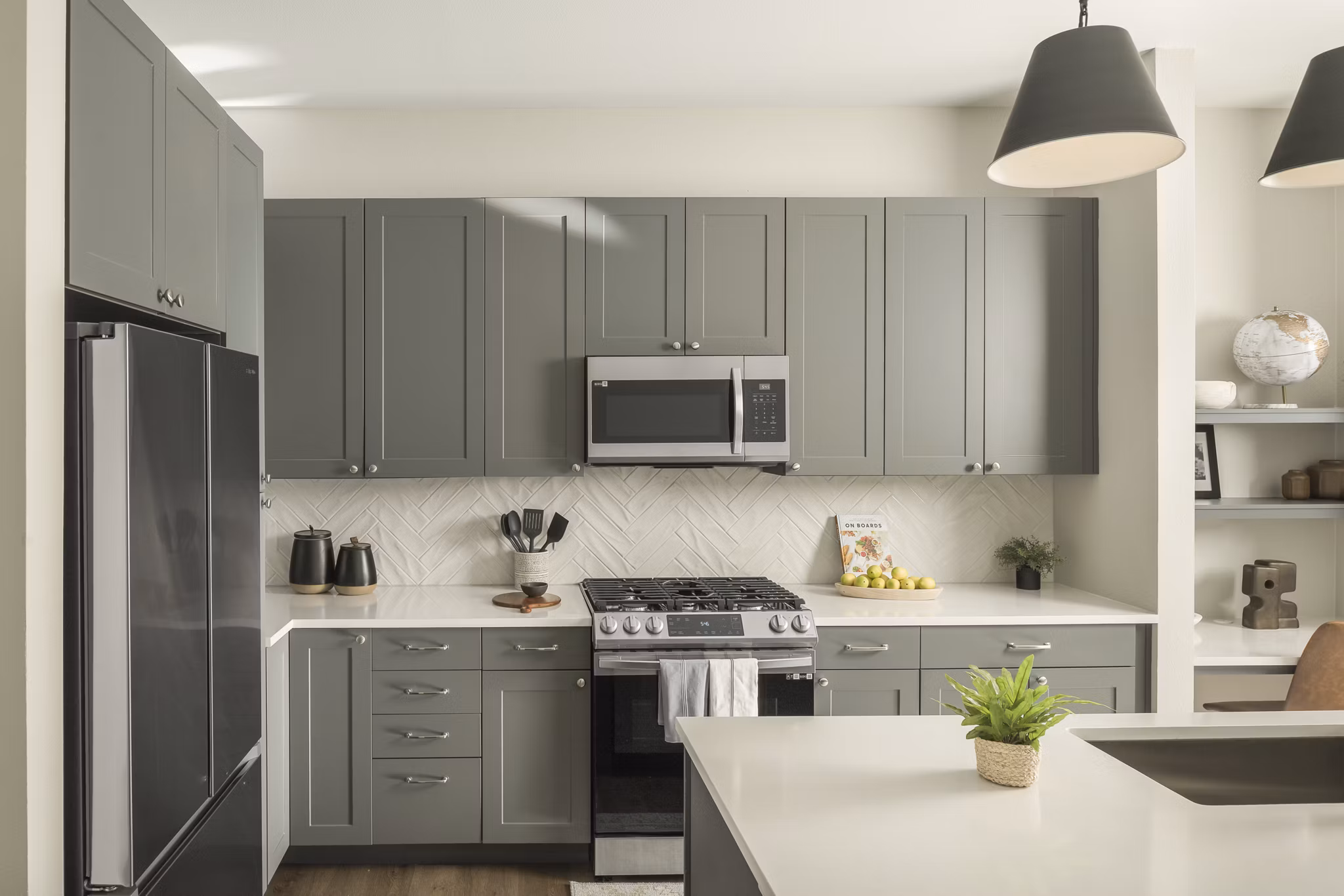 Modern kitchen with stainless steel appliances at Smith + Rio Apartments