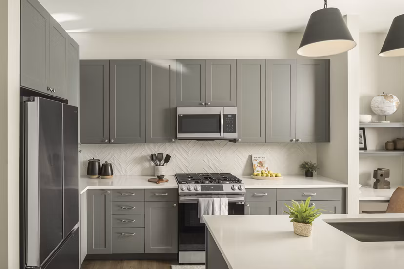 Modern kitchen with stainless steel appliances at Smith + Rio Apartments