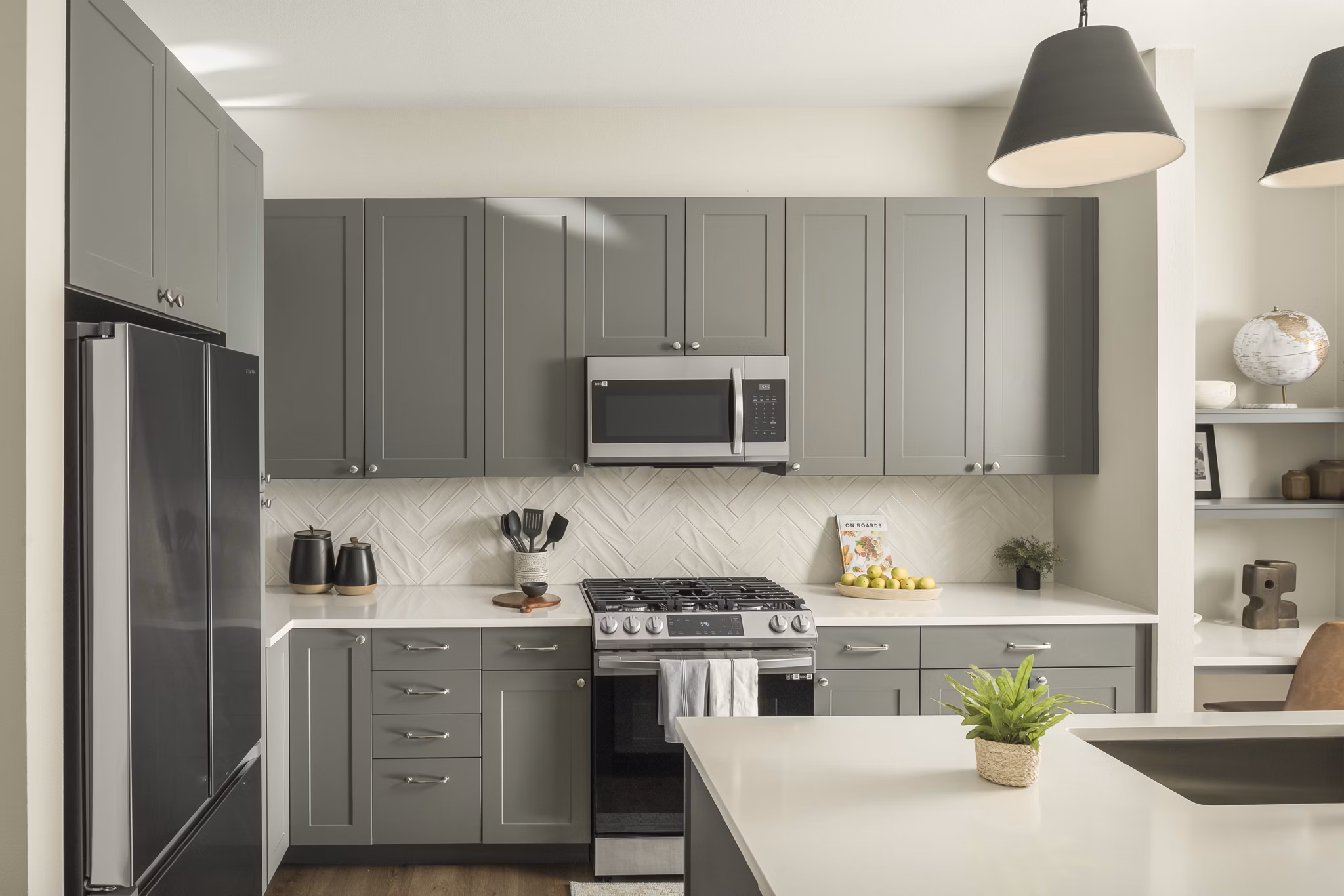 Modern kitchen with stainless steel appliances at Smith + Rio Apartments