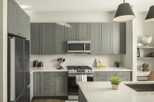 Modern kitchen with stainless steel appliances at Smith + Rio Apartments