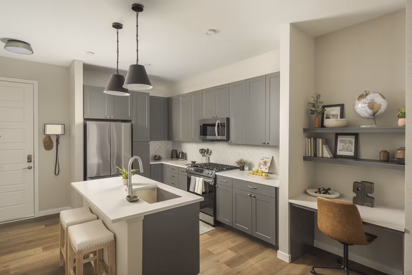 Modern kitchen with stainless steel appliances at Smith + Rio Apartments