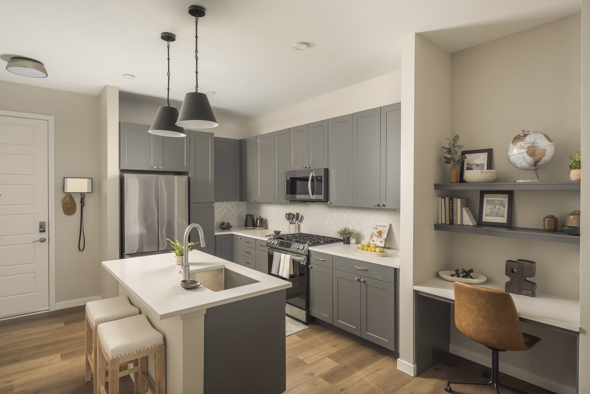 Modern kitchen with stainless steel appliances at Smith + Rio Apartments