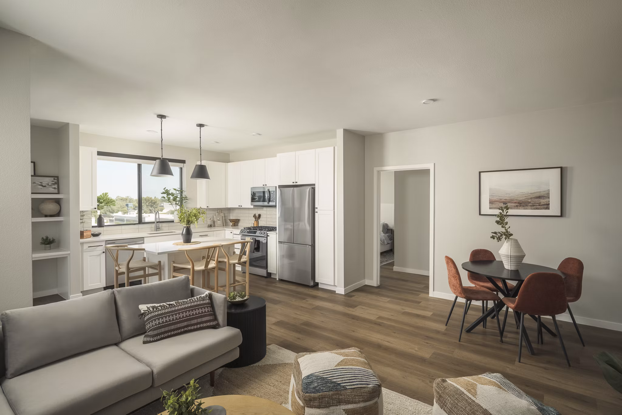 Living room with modern decor and large windows at Smith + Rio Apartments, showcasing luxury living in Greystar community