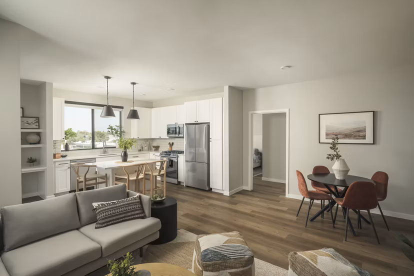 Living room with modern decor and large windows at Smith + Rio Apartments, showcasing luxury living in Greystar community