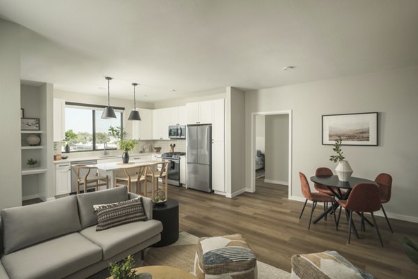 Living room with modern decor and large windows at Smith + Rio Apartments, showcasing luxury living in Greystar community
