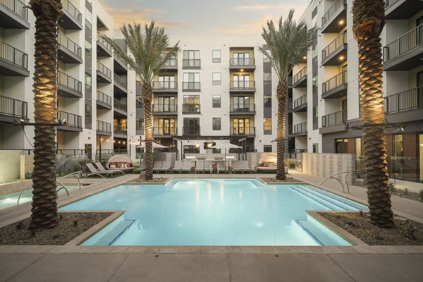 Serene pool area with stylish lounge chairs at Smith + Rio Apartments in Tempe, a luxury offering by Greystar